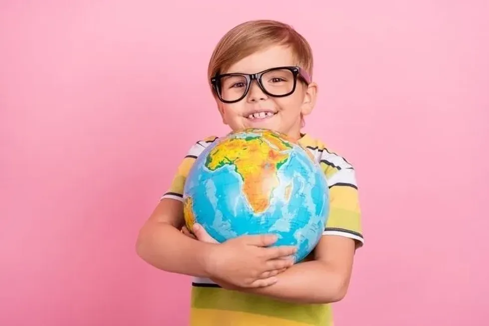 A boy hugging globe