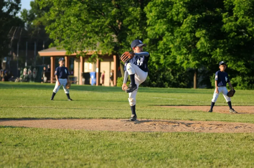 A boy in his ready position to throw the baseball