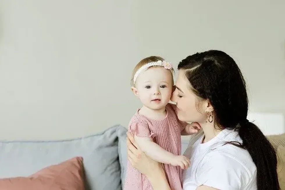 A mother holding her little girl