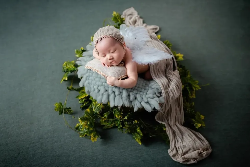 A newborn angel baby sleeping on a cozy blanket