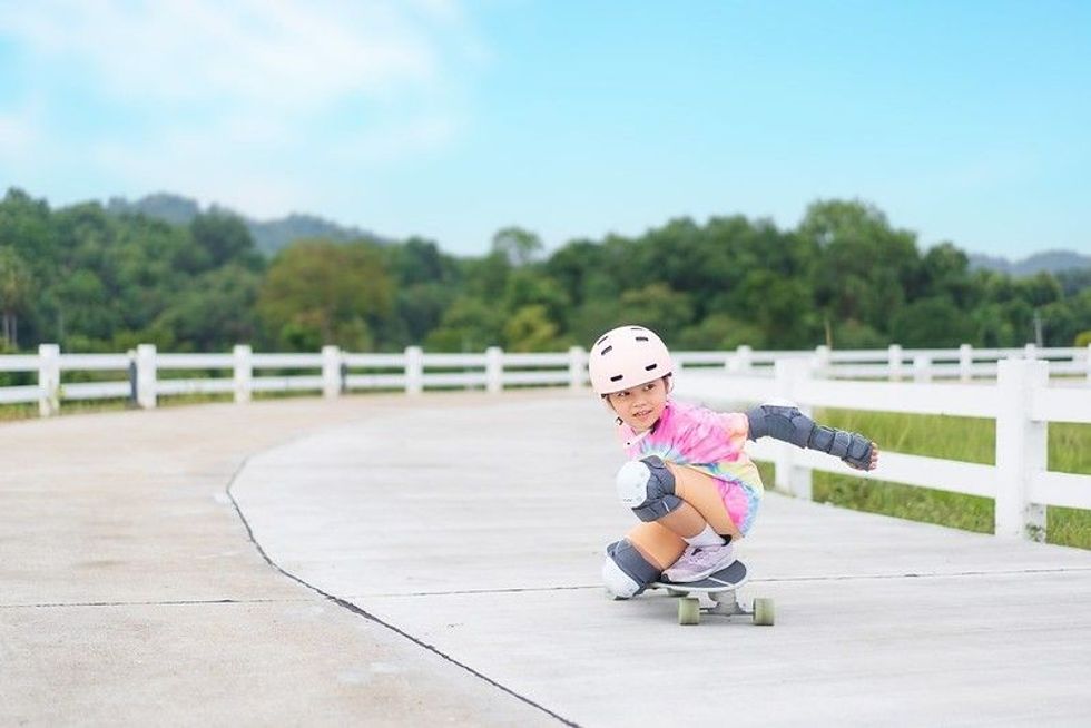 Asian girl playing on skates