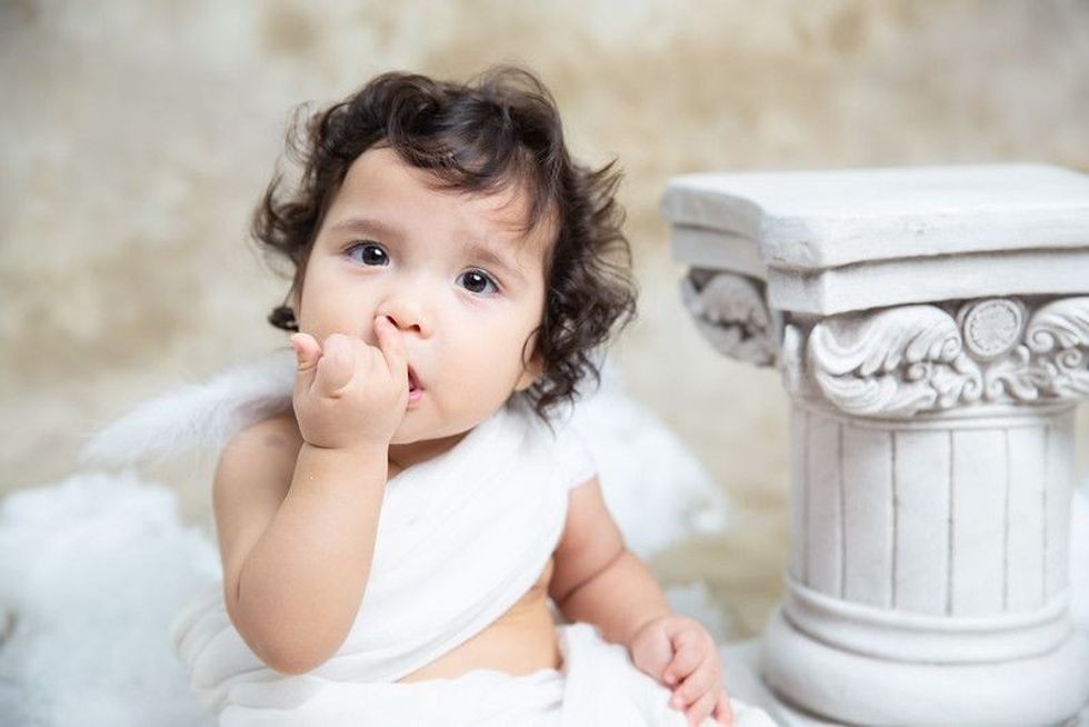 Baby in white greek costume