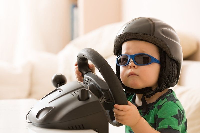 Boy in a helmet playing with Computer