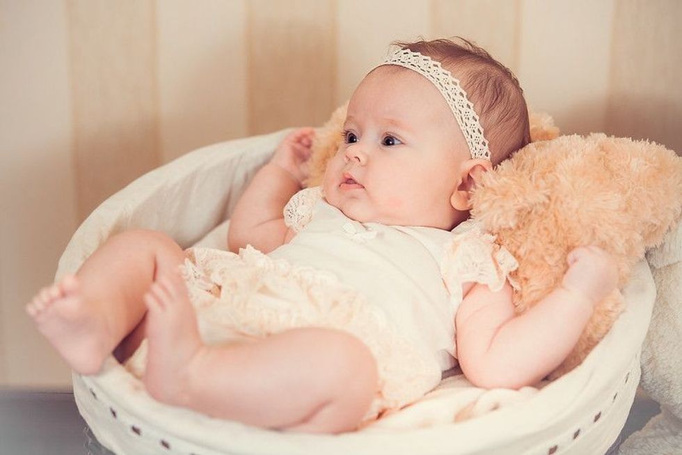 Child's portrait in a basket.