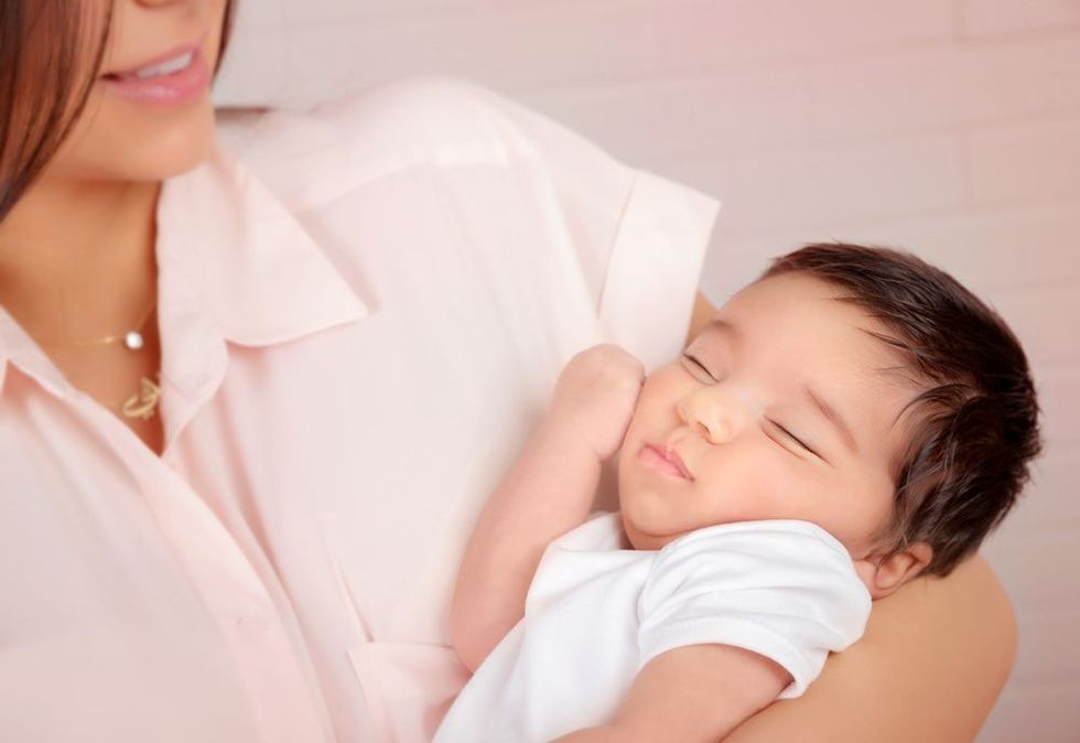 Closeup portrait of cute arabic newborn baby on mothers hands