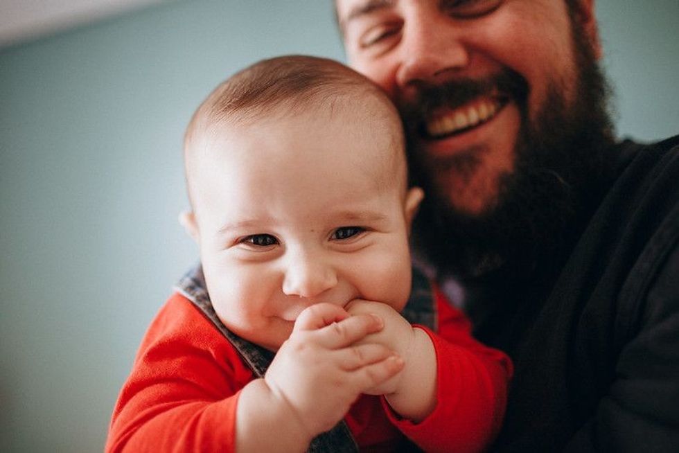 Cute baby with father smiling.