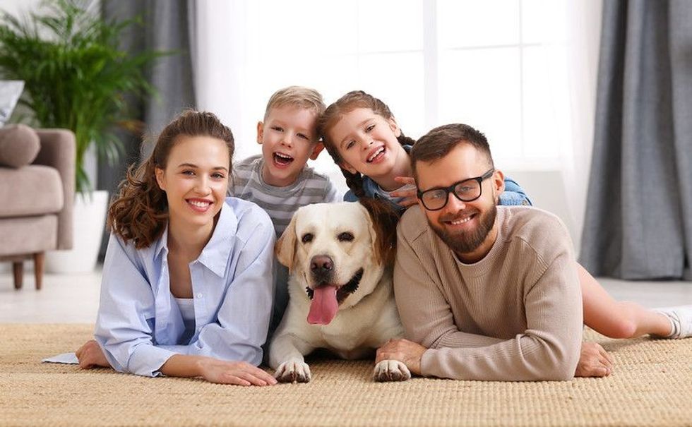 Cute family with dog in the middle.