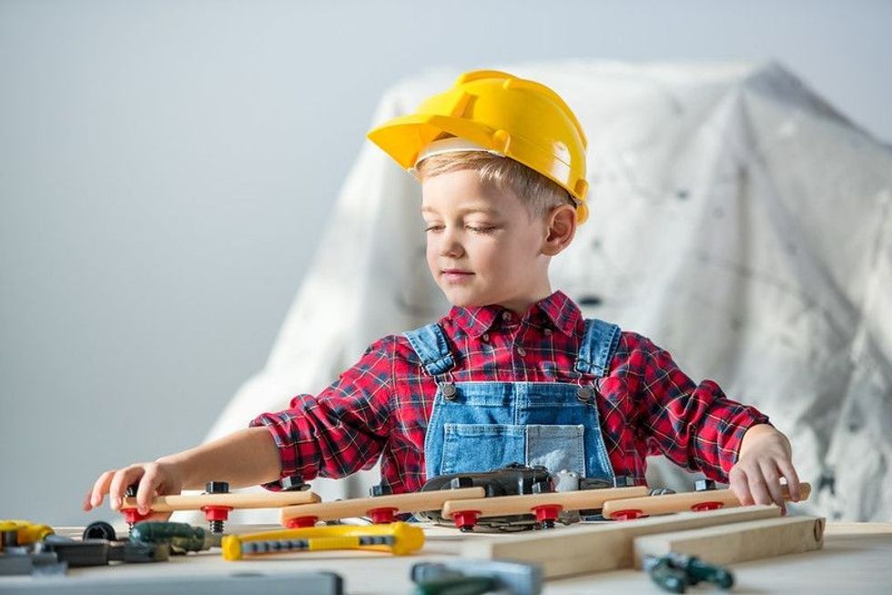 Cute little boy in yellow hard hat