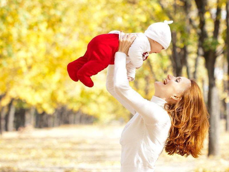 Happy young mother playing with little daughter