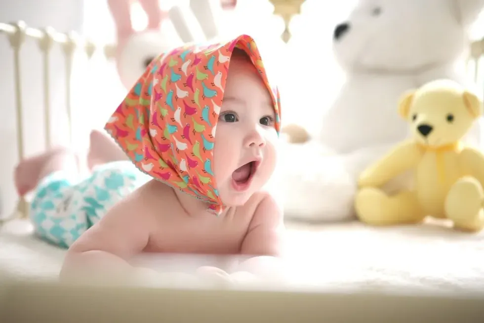 Newborn baby boy playing with toys