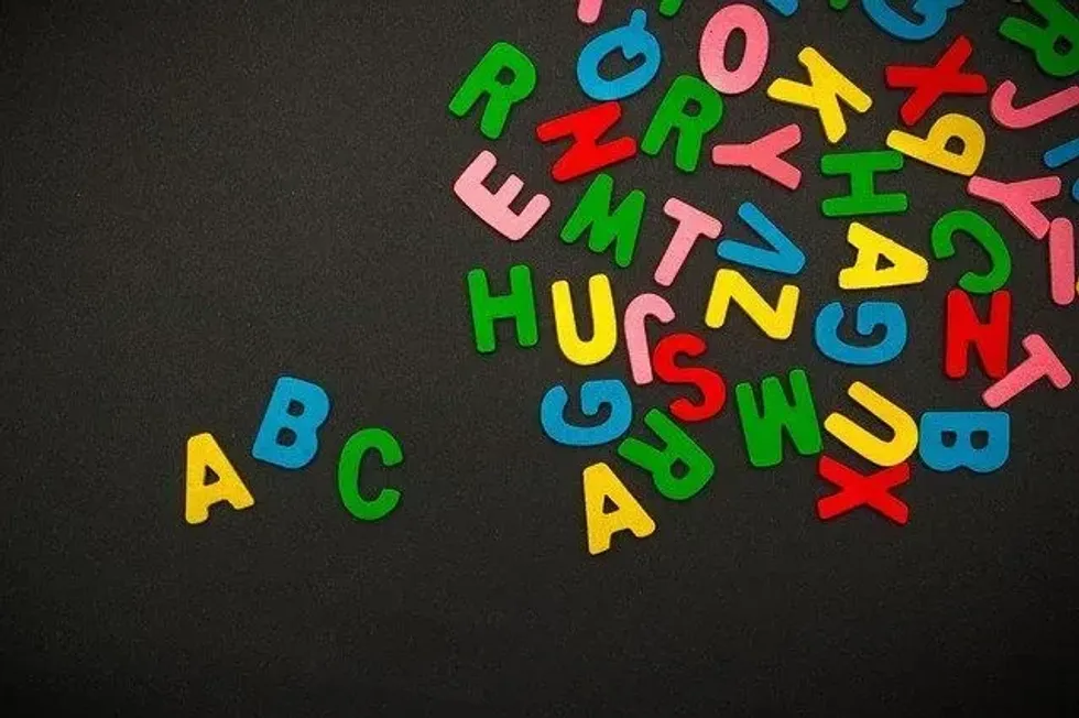 Scattered alphabets on black background