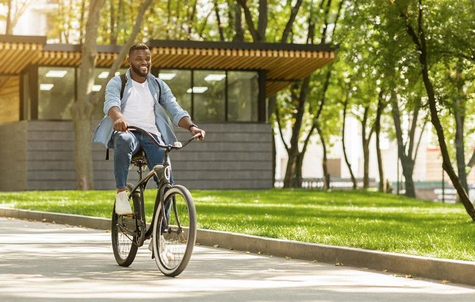 Smiling young man on bicycle.