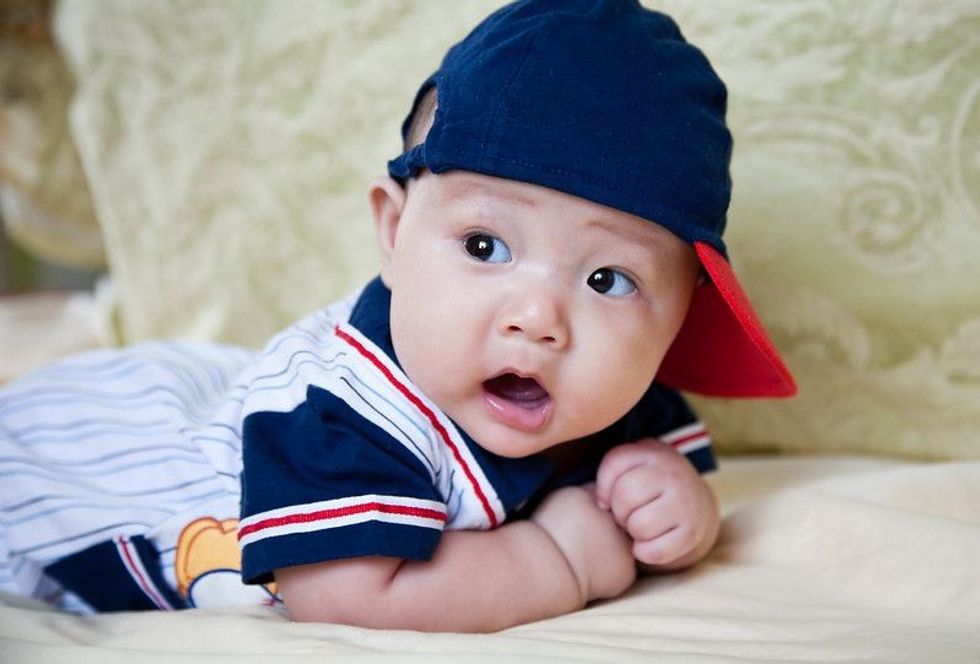 Surprised little boy resting on bed