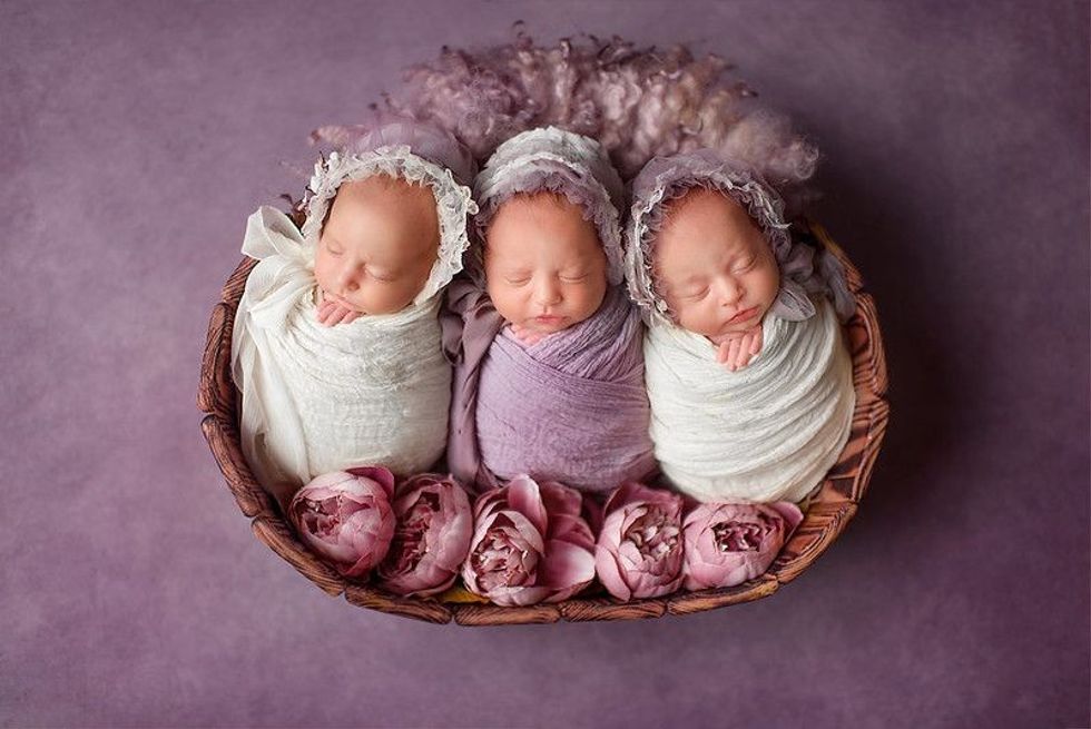 Three twin sisters are sleeping sweetly.